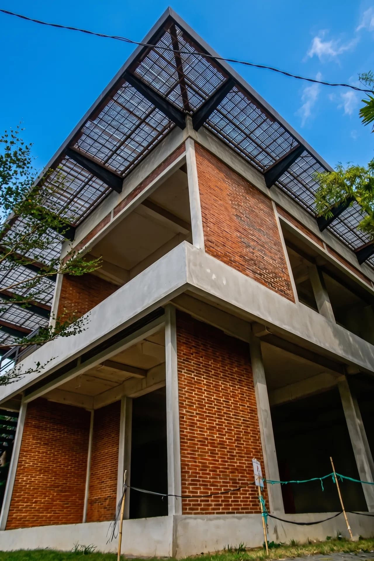 BERAWA 1053 facade — the signature peaked canopy roof over exposed brick and concrete